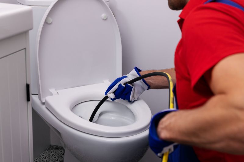 Plumber Working on a Toilet